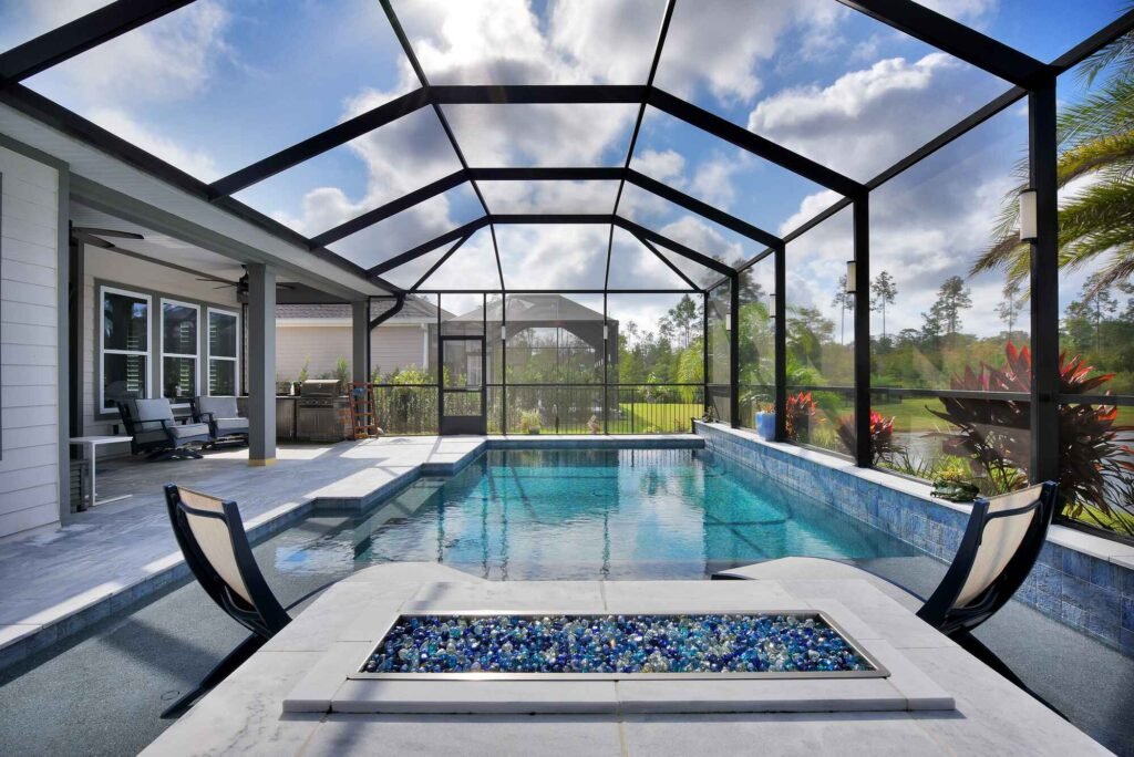 Completed pool screen enclosure installation in Fort Pierce, FL with modern backyard pool setup